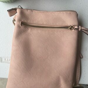 Cute cross body bag. The color is like a soft salmon color. Hard to describe